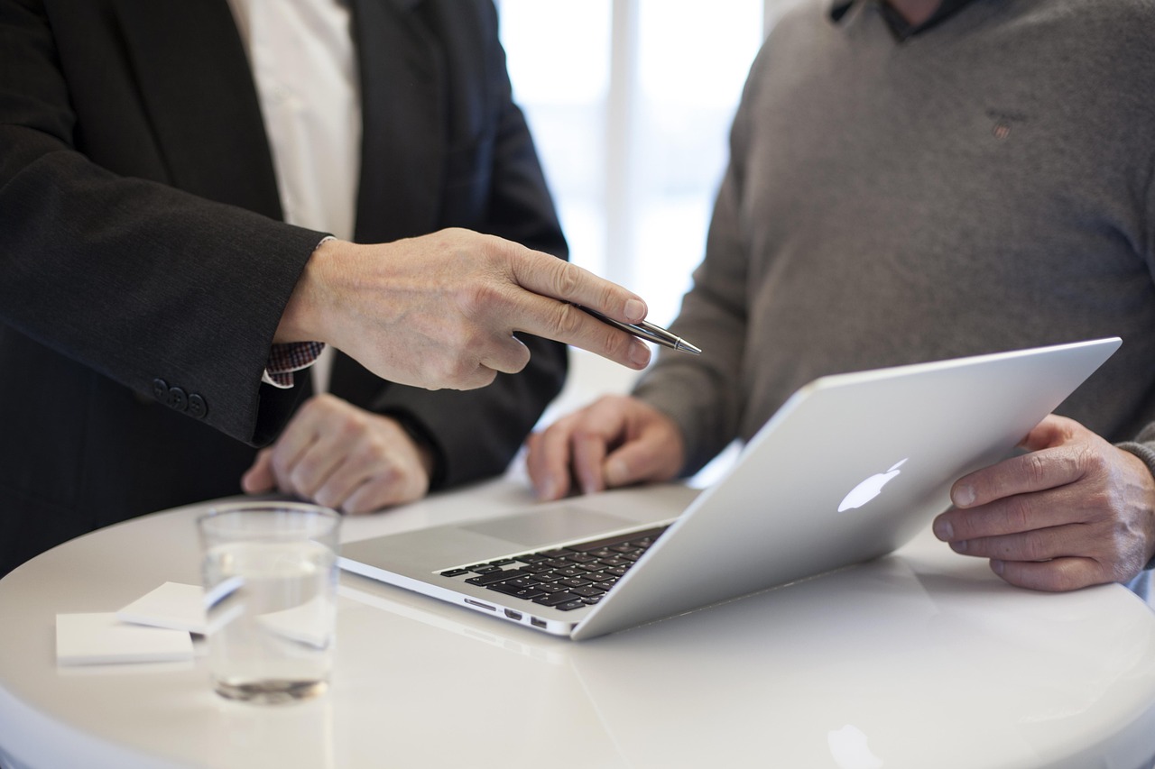 Payroll support setup and onboarding with team reviewing employee payroll information on laptop