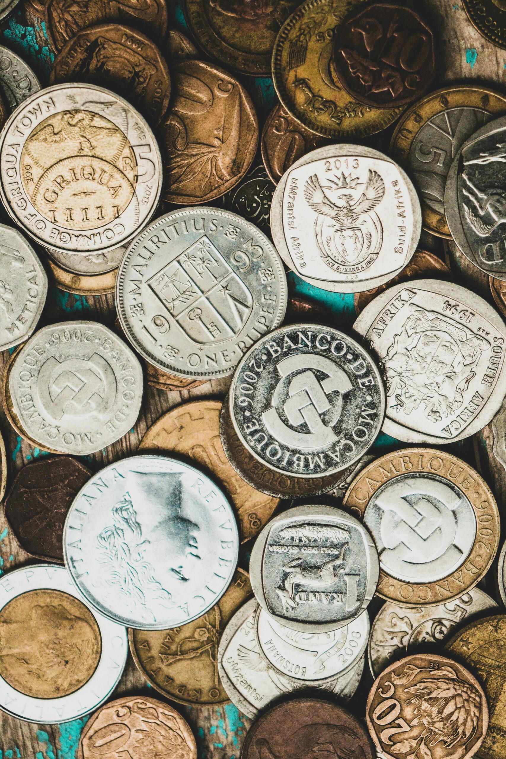 A detailed close-up of a collection of international coins showcasing various currencies, representing bookkeeping salisbury nc