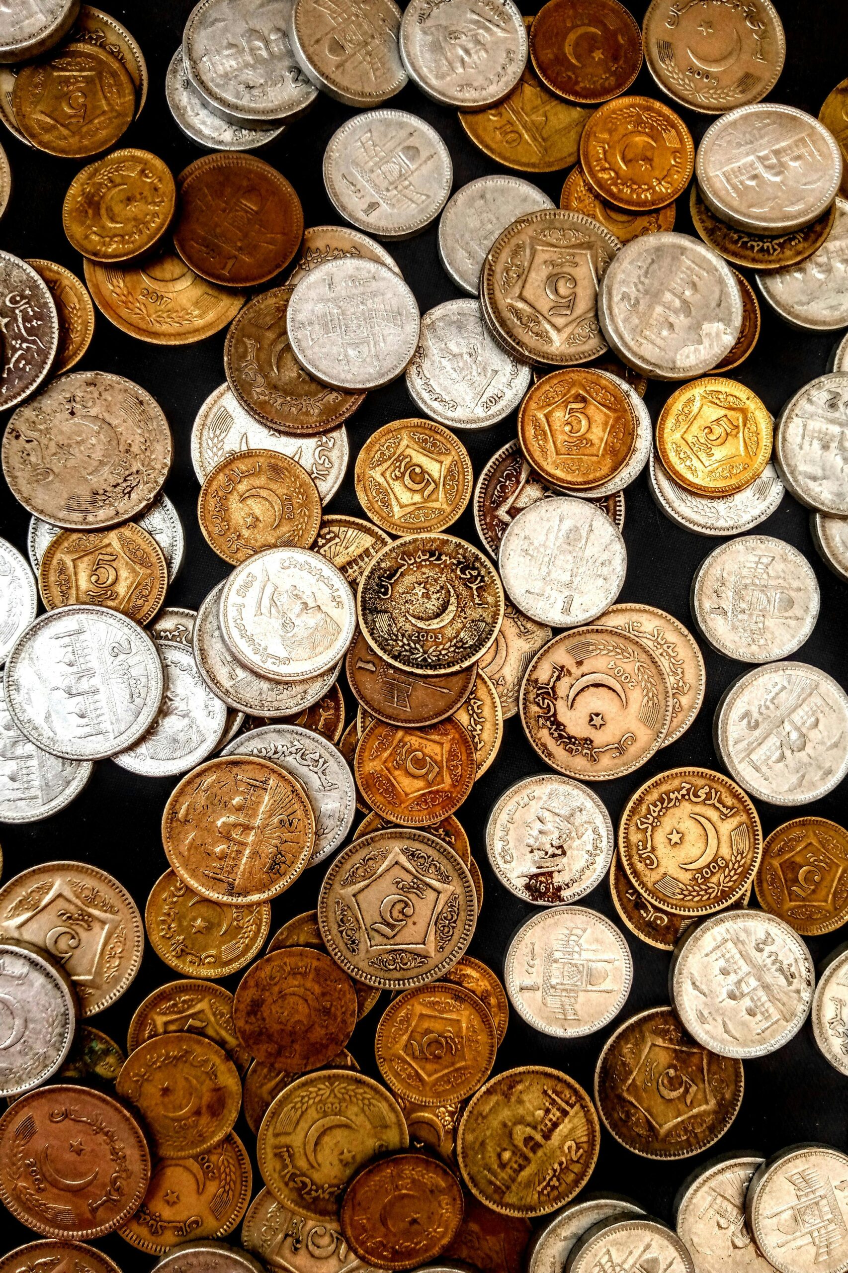 A diverse collection of vintage and collectible coins representing bookkeeping concord nc